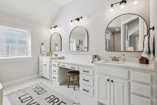 bathroom with vanity and lofted ceiling