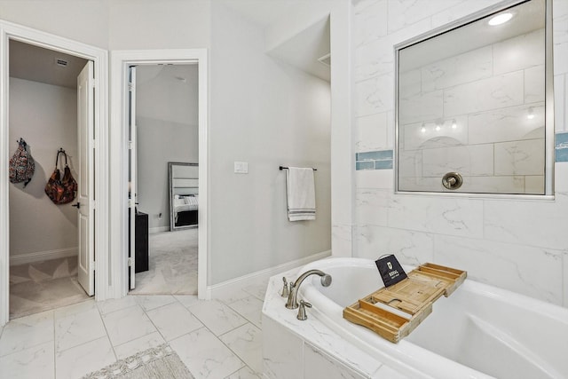 bathroom featuring tiled tub