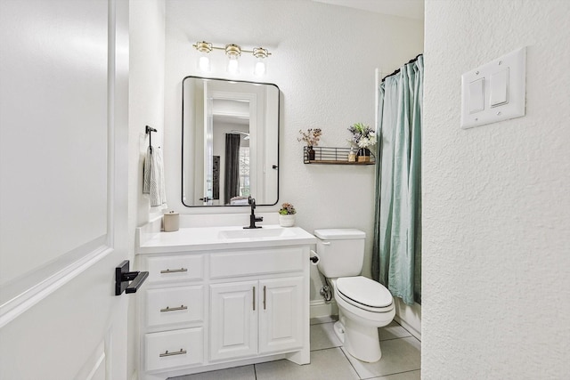 bathroom featuring tile patterned flooring, vanity, and toilet