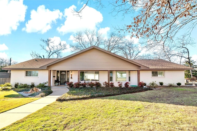 ranch-style house with covered porch and a front yard