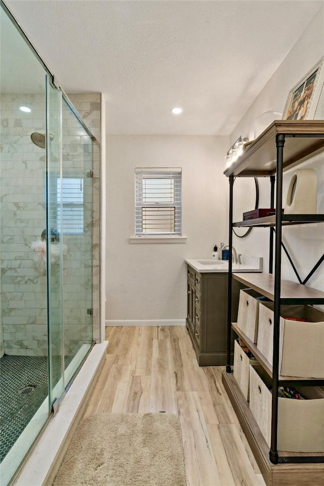 bathroom featuring vanity, an enclosed shower, and hardwood / wood-style floors