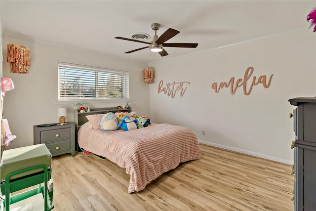 bedroom featuring crown molding, ceiling fan, and light hardwood / wood-style flooring