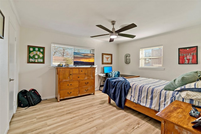 bedroom featuring crown molding, ceiling fan, and light hardwood / wood-style floors