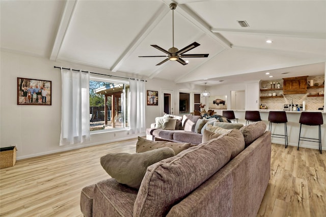 living room with ceiling fan, lofted ceiling with beams, and light wood-type flooring