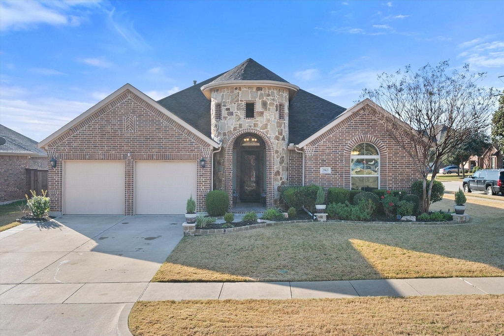 view of front of property featuring a garage and a front yard