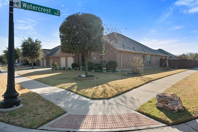 view of front of house featuring a garage and a front yard