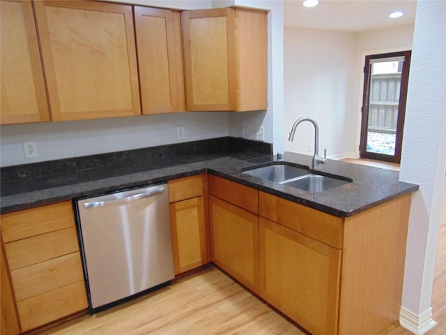 kitchen featuring sink, dark stone countertops, stainless steel dishwasher, kitchen peninsula, and light wood-type flooring