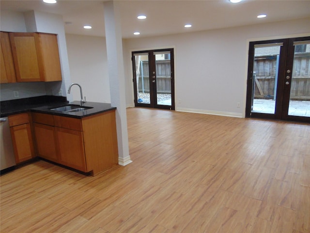 kitchen featuring sink, french doors, and light wood-type flooring