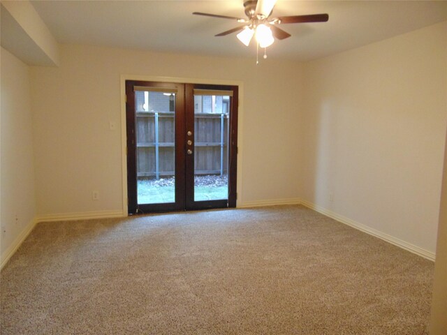 empty room featuring carpet floors, ceiling fan, and french doors