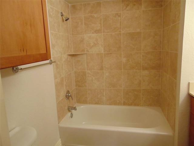 full bathroom featuring vanity, toilet, and tiled shower / bath combo