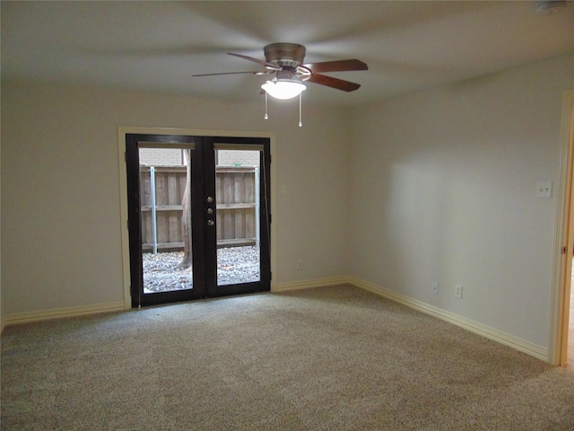 carpeted empty room with french doors and ceiling fan