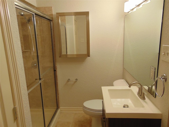 bathroom featuring vanity, toilet, an enclosed shower, and tile patterned flooring