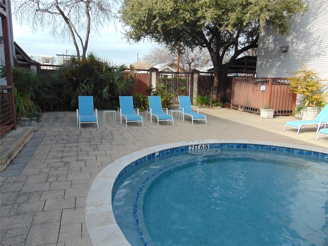 view of swimming pool with a patio