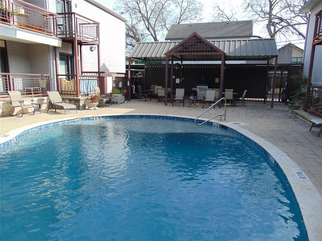 view of swimming pool featuring a gazebo and a patio