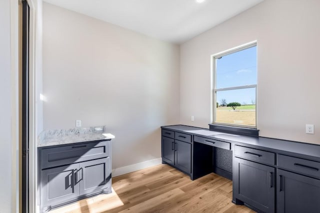 kitchen featuring light wood-type flooring and built in desk