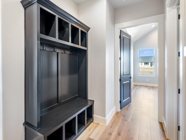 mudroom featuring lofted ceiling and light wood-type flooring