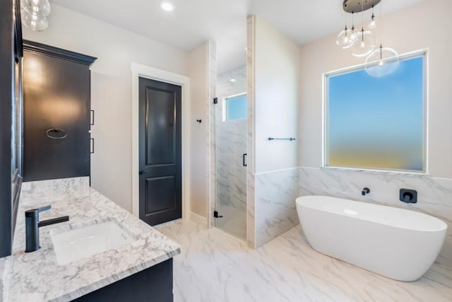 bathroom featuring a chandelier, vanity, and separate shower and tub