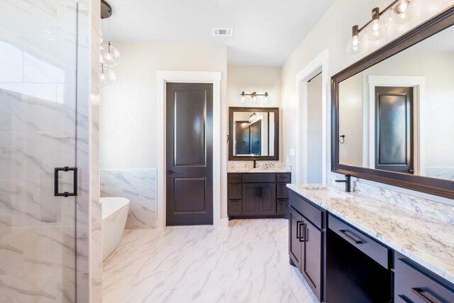 bathroom featuring vanity, independent shower and bath, and tile walls