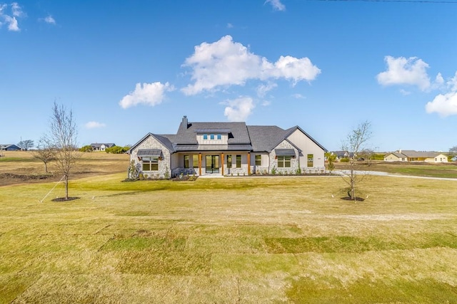 view of front of house with covered porch and a front lawn