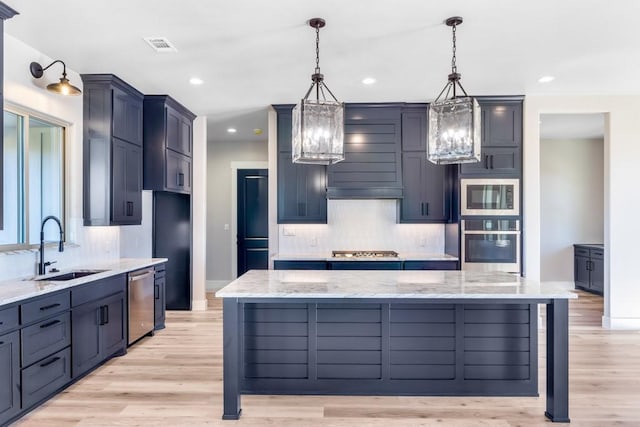 kitchen with decorative light fixtures, a spacious island, and stainless steel appliances