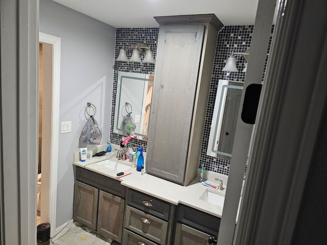 bathroom with vanity and decorative backsplash