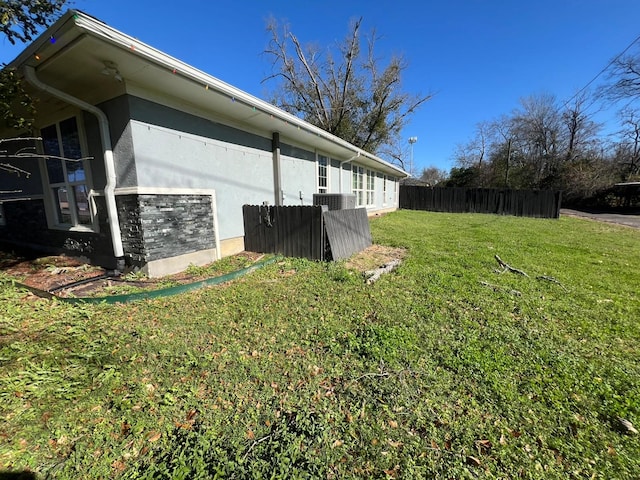 view of property exterior featuring a lawn