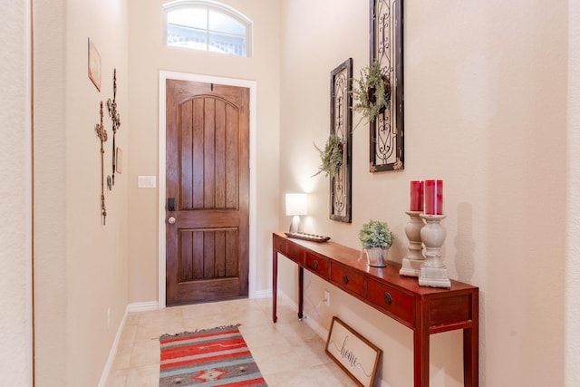 foyer entrance with light tile patterned flooring