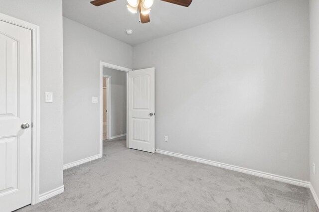 unfurnished bedroom with light carpet and ceiling fan