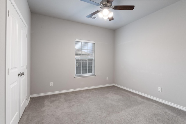 carpeted empty room featuring ceiling fan