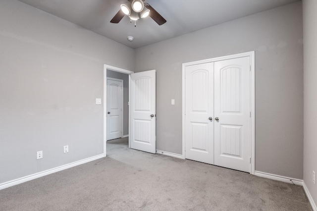 unfurnished bedroom featuring light carpet, a closet, and ceiling fan