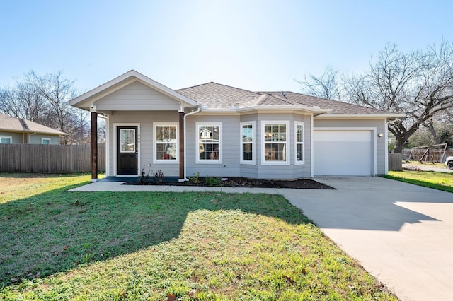 ranch-style house featuring a garage and a front lawn