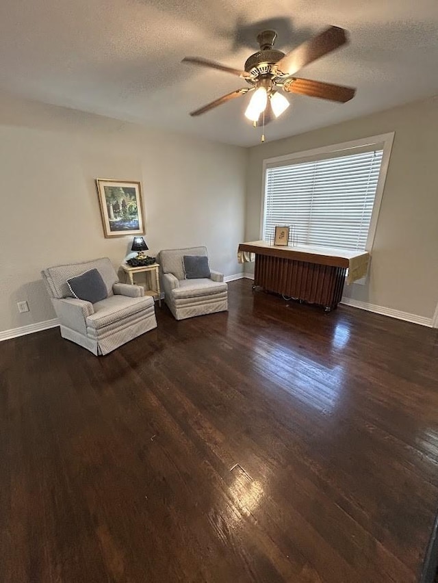 unfurnished room with wood finished floors, baseboards, and a textured ceiling