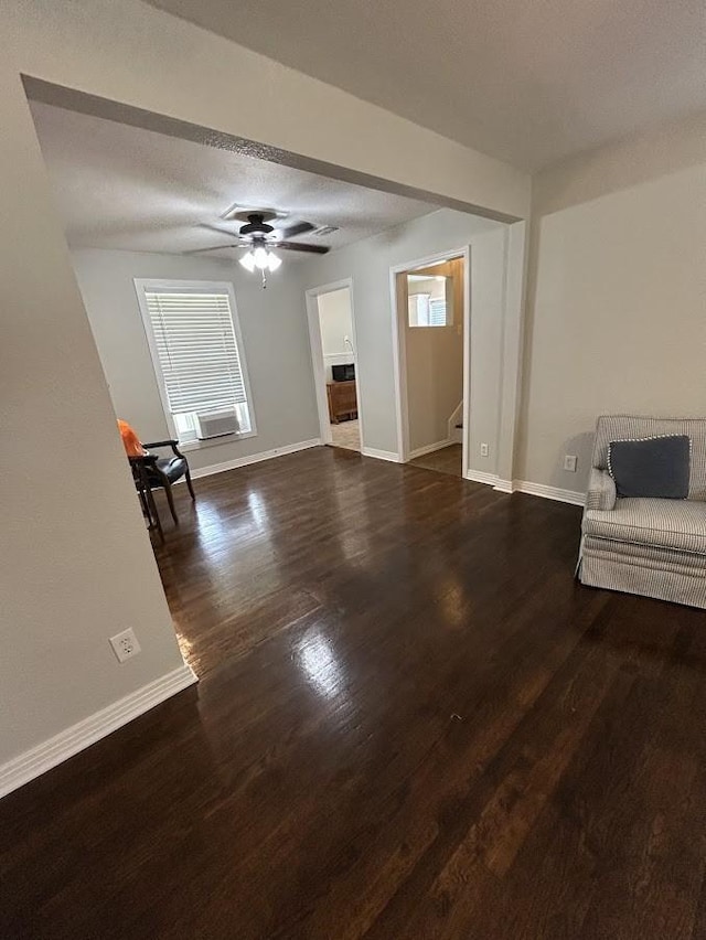 unfurnished living room featuring baseboards and wood finished floors