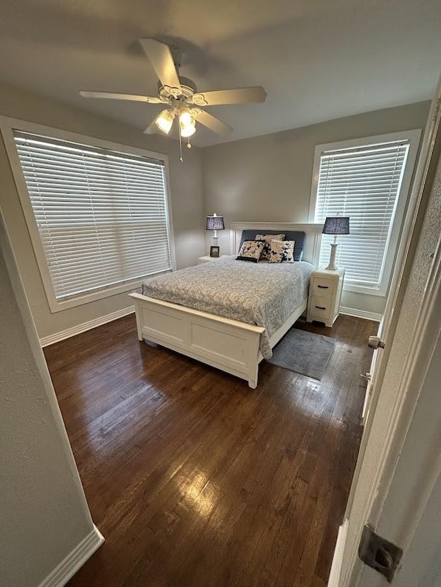 bedroom featuring dark wood-type flooring, baseboards, and ceiling fan