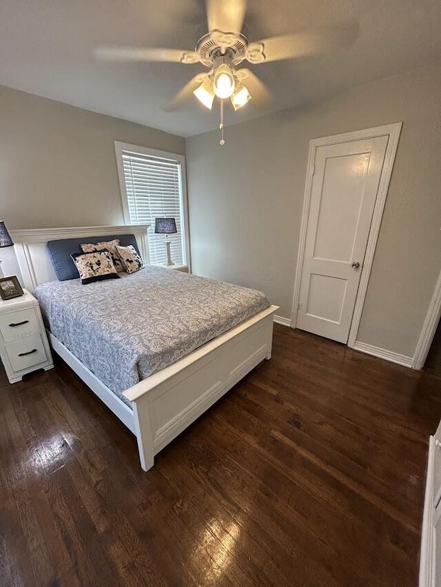 bedroom with baseboards, dark wood-style flooring, and ceiling fan