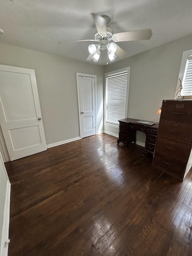 unfurnished bedroom featuring dark wood finished floors, ceiling fan, and baseboards