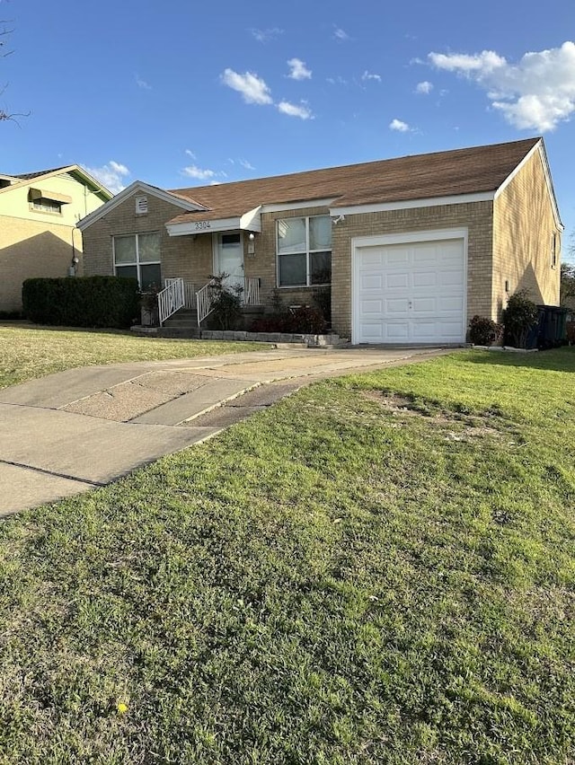 single story home featuring brick siding, an attached garage, concrete driveway, and a front yard