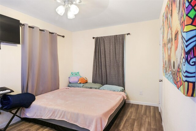 bedroom featuring ceiling fan and dark wood-type flooring