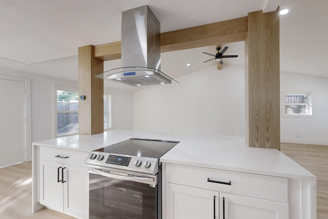 kitchen featuring stainless steel electric range oven, light stone counters, lofted ceiling with beams, island range hood, and white cabinets