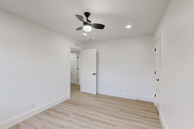 empty room featuring ceiling fan and light hardwood / wood-style flooring