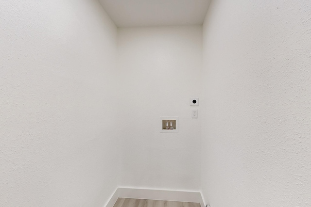 washroom featuring hookup for a washing machine, hardwood / wood-style flooring, and electric dryer hookup