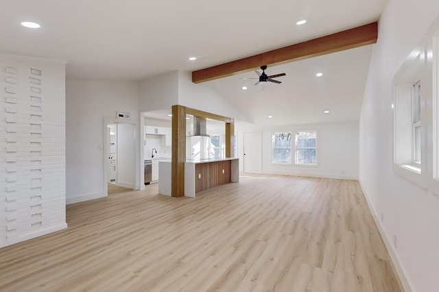 unfurnished living room with vaulted ceiling with beams, ceiling fan, sink, and light wood-type flooring