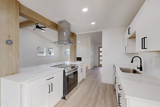 kitchen with white cabinets, sink, stainless steel electric stove, and wall chimney range hood