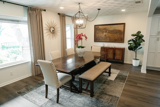 dining space featuring dark wood-style floors, baseboards, and a healthy amount of sunlight