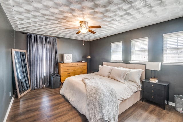 bedroom with ceiling fan and dark wood-type flooring