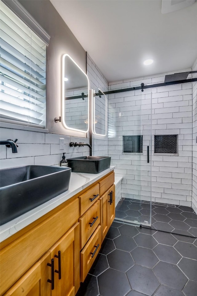 bathroom featuring tile patterned flooring, vanity, and a shower with shower door