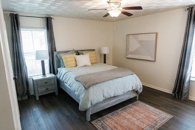 bedroom with ceiling fan and dark hardwood / wood-style flooring