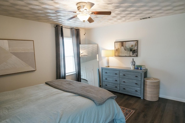 bedroom featuring dark hardwood / wood-style flooring and ceiling fan