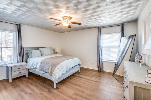 bedroom featuring ceiling fan and light hardwood / wood-style floors