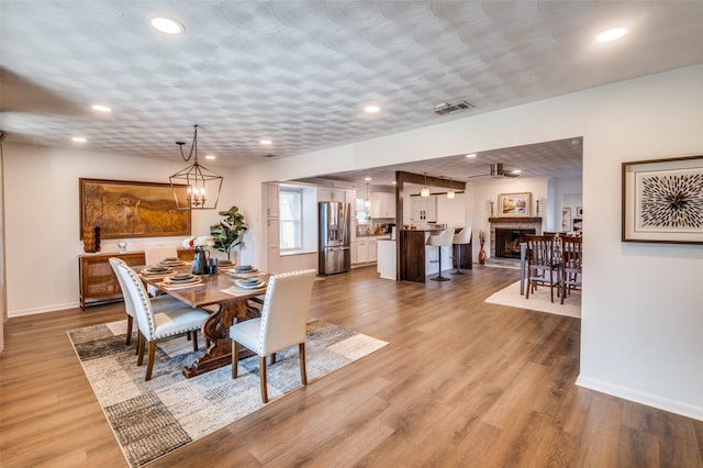 dining room with hardwood / wood-style flooring and an inviting chandelier